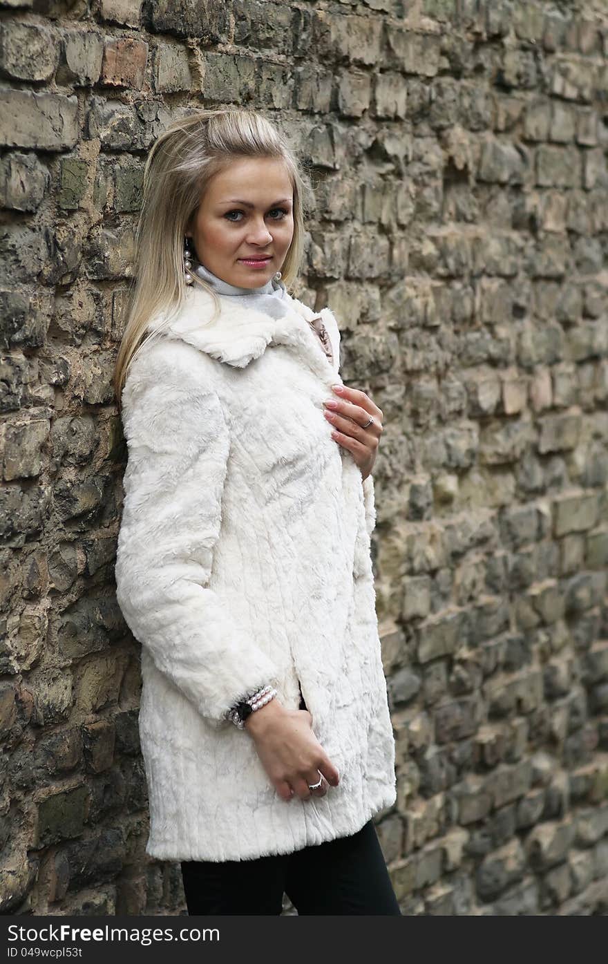 Upset Young Woman In White Fur Coat