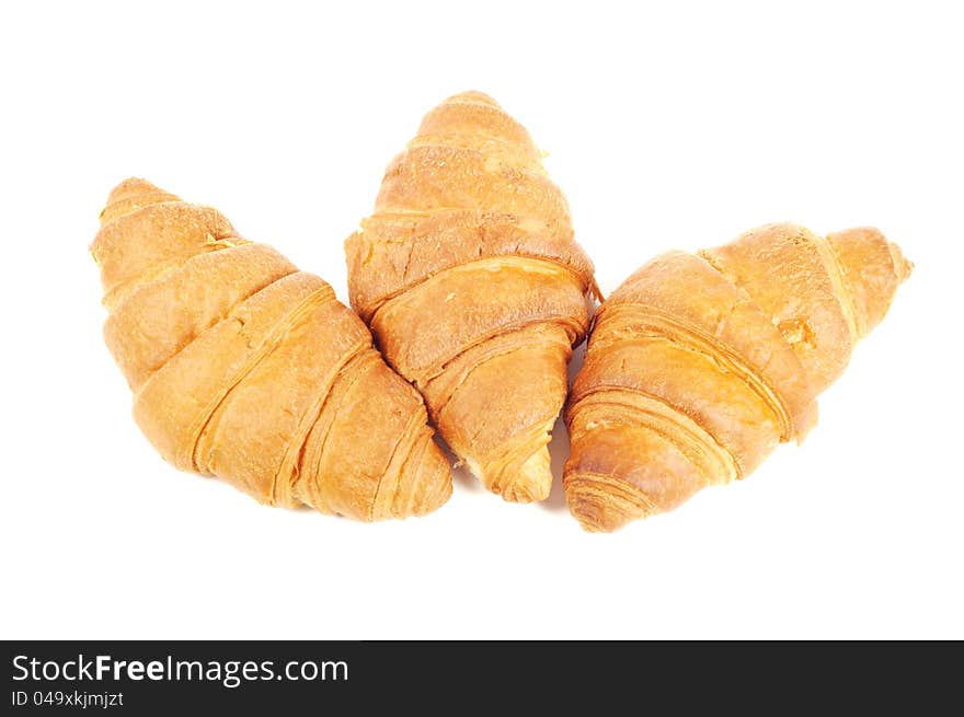 Four french croissants on white background