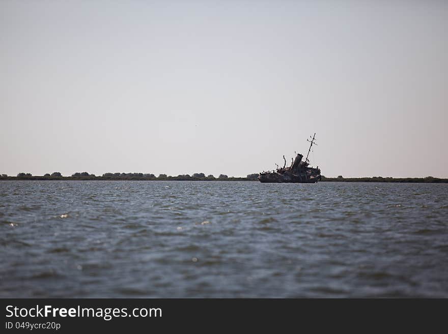 Abandoned wrecked ship in seaside landscape