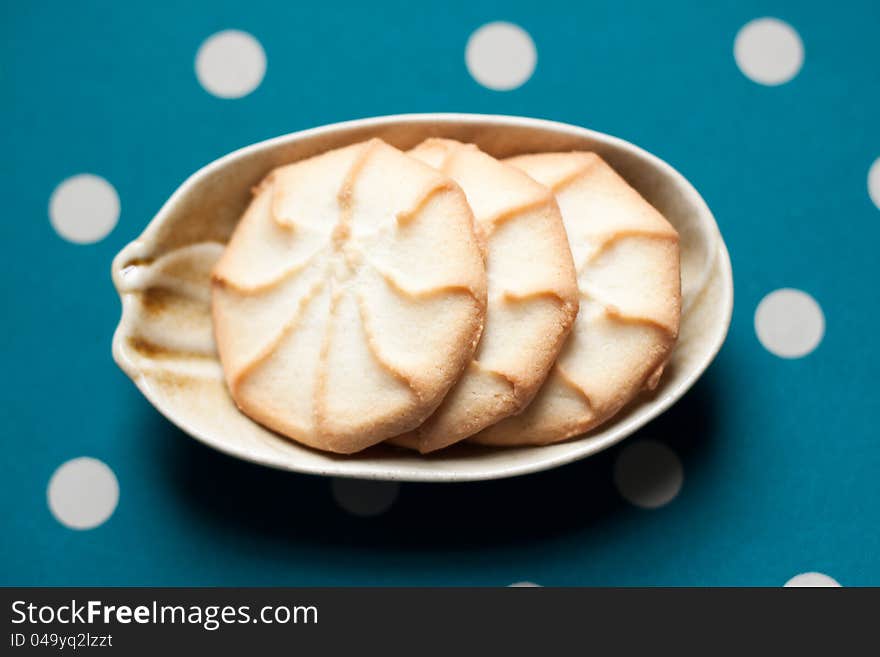 Plate of cookies on green polka dot background