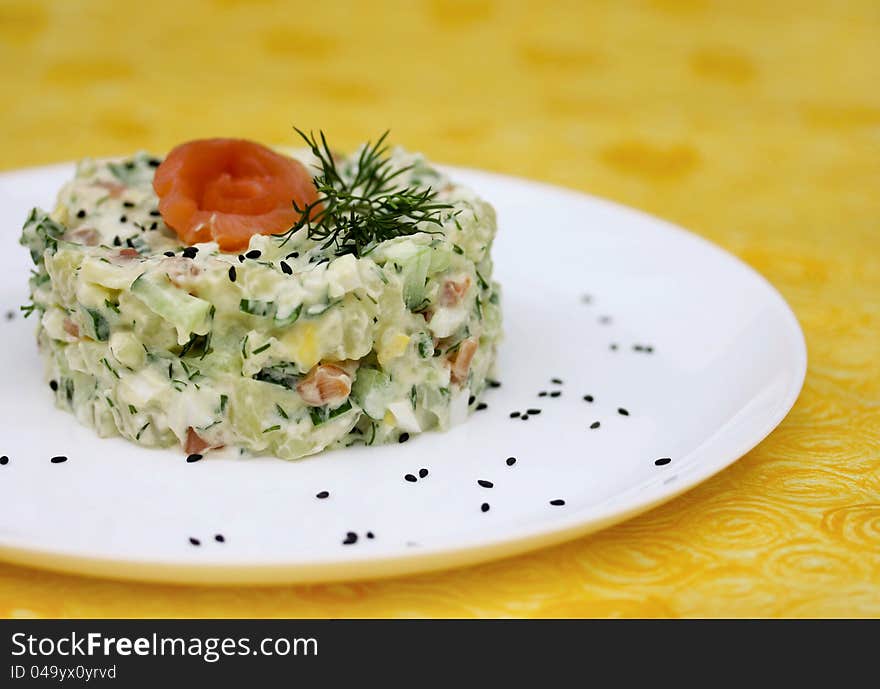 Holiday salad with salted fish and fresh cucumber