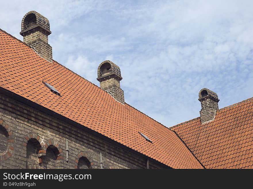 Roof of an old monastery against blue sky