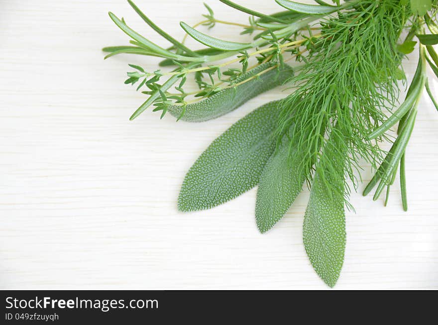 Some culinary herbal leaves on the wooden board. Some culinary herbal leaves on the wooden board