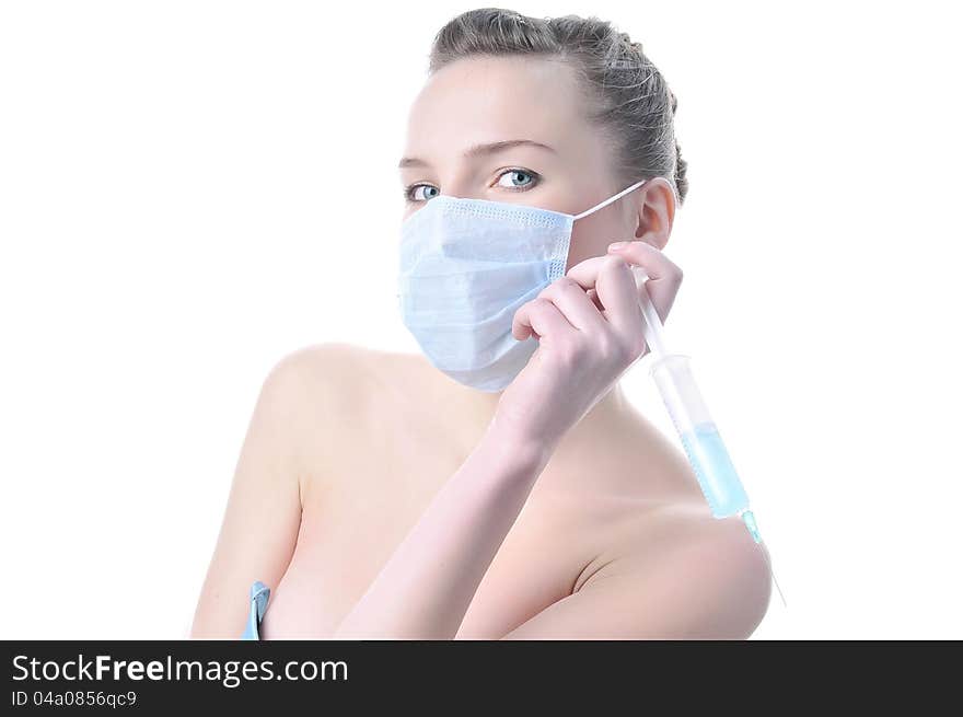 Beautiful passionate nurse with a syringe in a mask