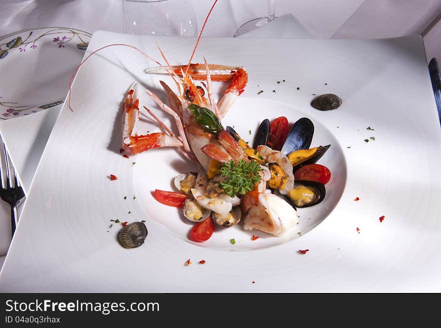 Prepared sea food scampi and mussel decorated with vegetables. Prepared sea food scampi and mussel decorated with vegetables