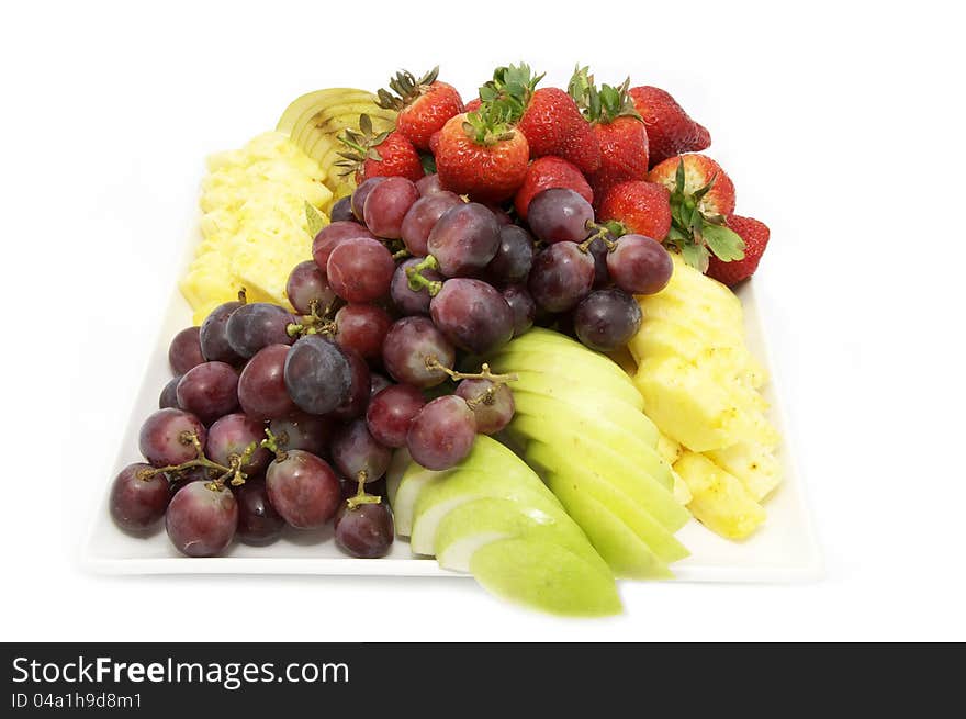 A plate of ripe fruit on a white background