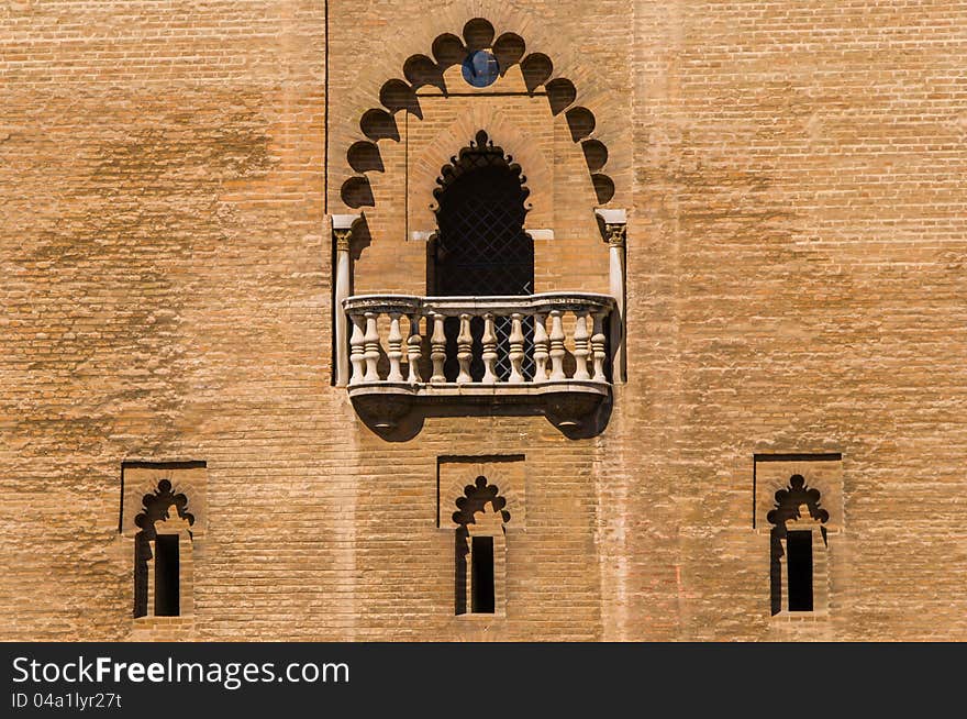 Arabic-style wall with 3 windows and one open balcony above. Arabic-style wall with 3 windows and one open balcony above.