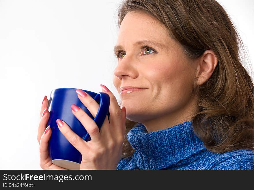 Closeup of a beautiful caucasian woman in her 40s holding a nice blue cup of warm beverage. Closeup of a beautiful caucasian woman in her 40s holding a nice blue cup of warm beverage