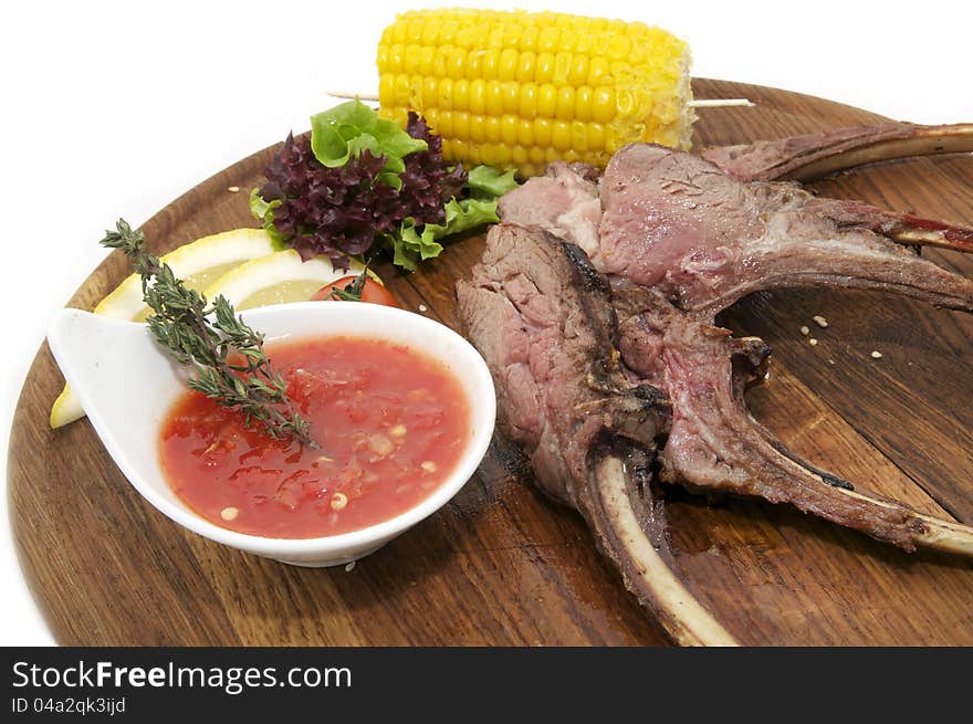 Grilled ribs with sauce and corn on a plate