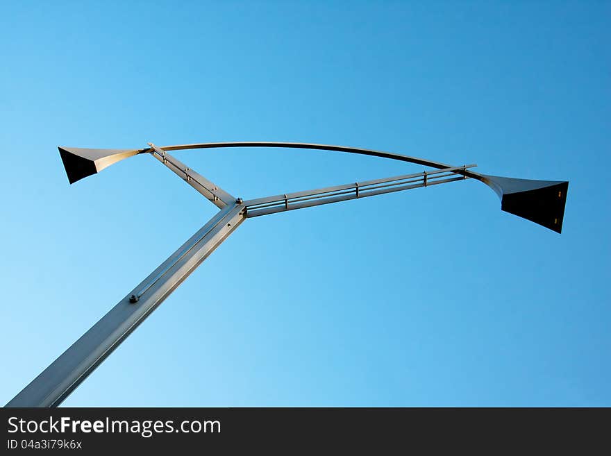 Modern designed city lamp over the blue sky. Modern designed city lamp over the blue sky