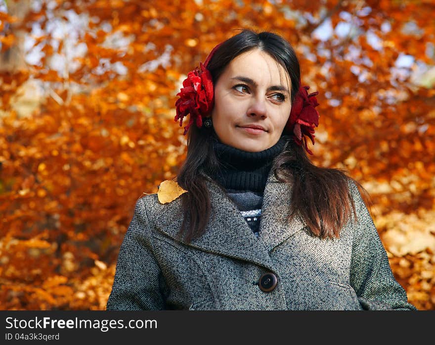 Close up portrait of a young woman with autumn trees on the background. Close up portrait of a young woman with autumn trees on the background.