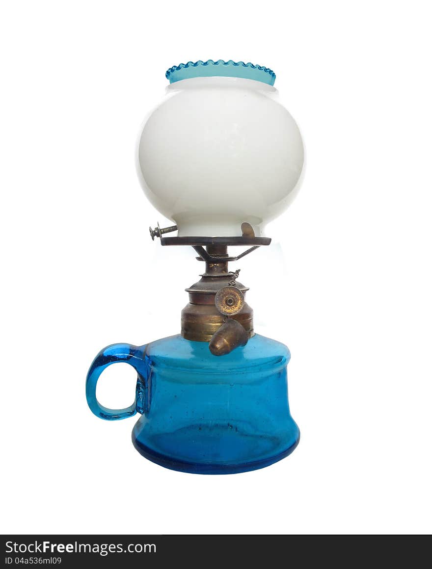 Antique blue glass oil lamp with a white globe. Isolated on white. Antique blue glass oil lamp with a white globe. Isolated on white.