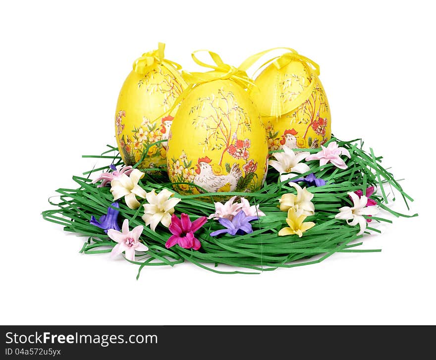 Three decorated easter eggs in the grass with hyacinth