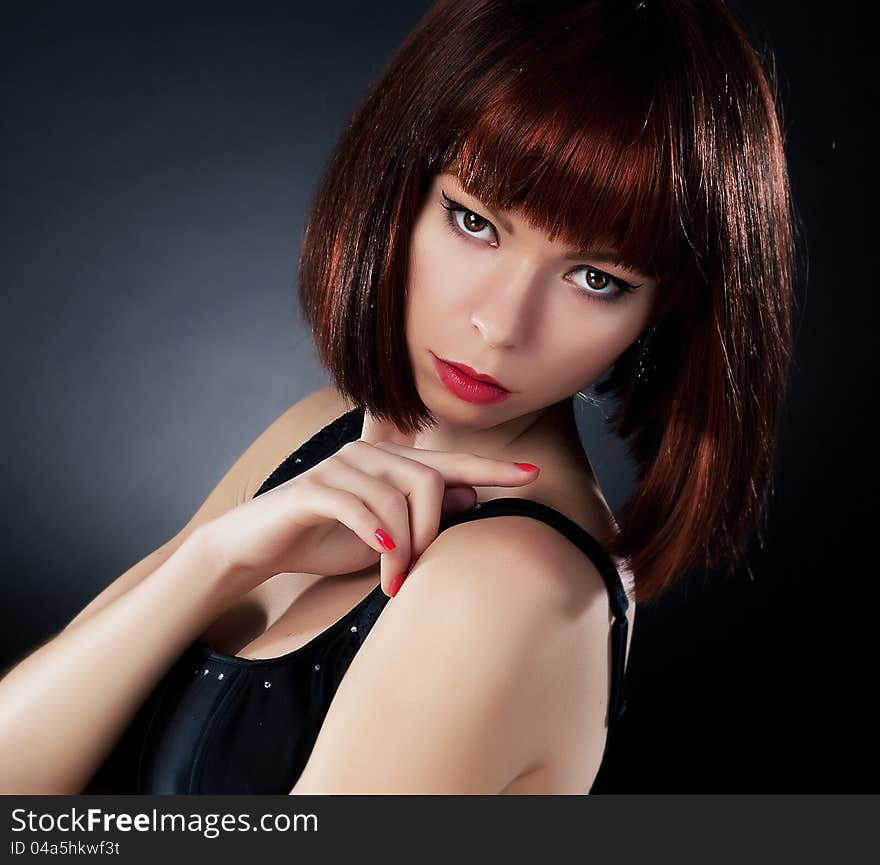 Beauty. Beautiful red hair woman over dark background. Beauty. Beautiful red hair woman over dark background