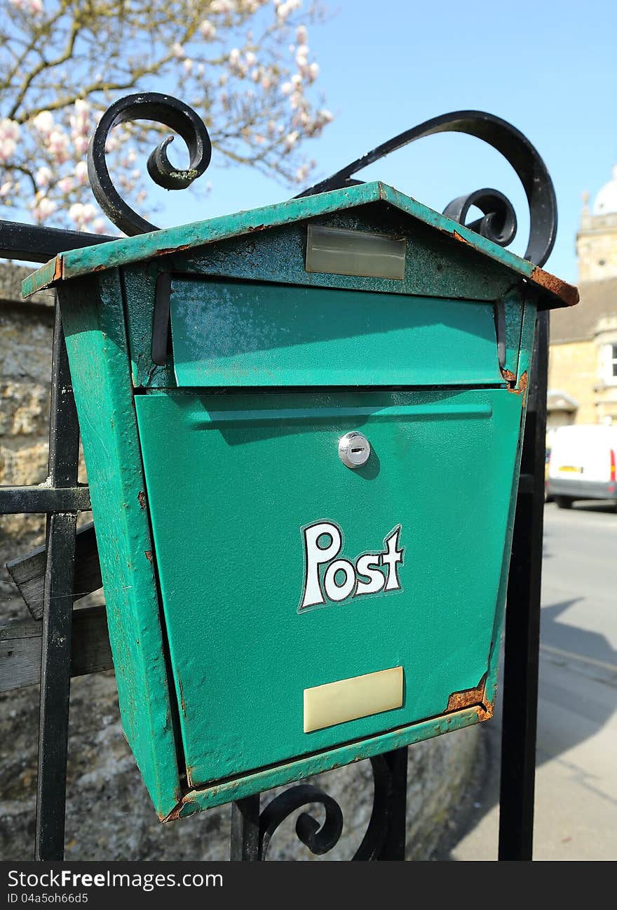 A post box showing digns of weather damage. A post box showing digns of weather damage