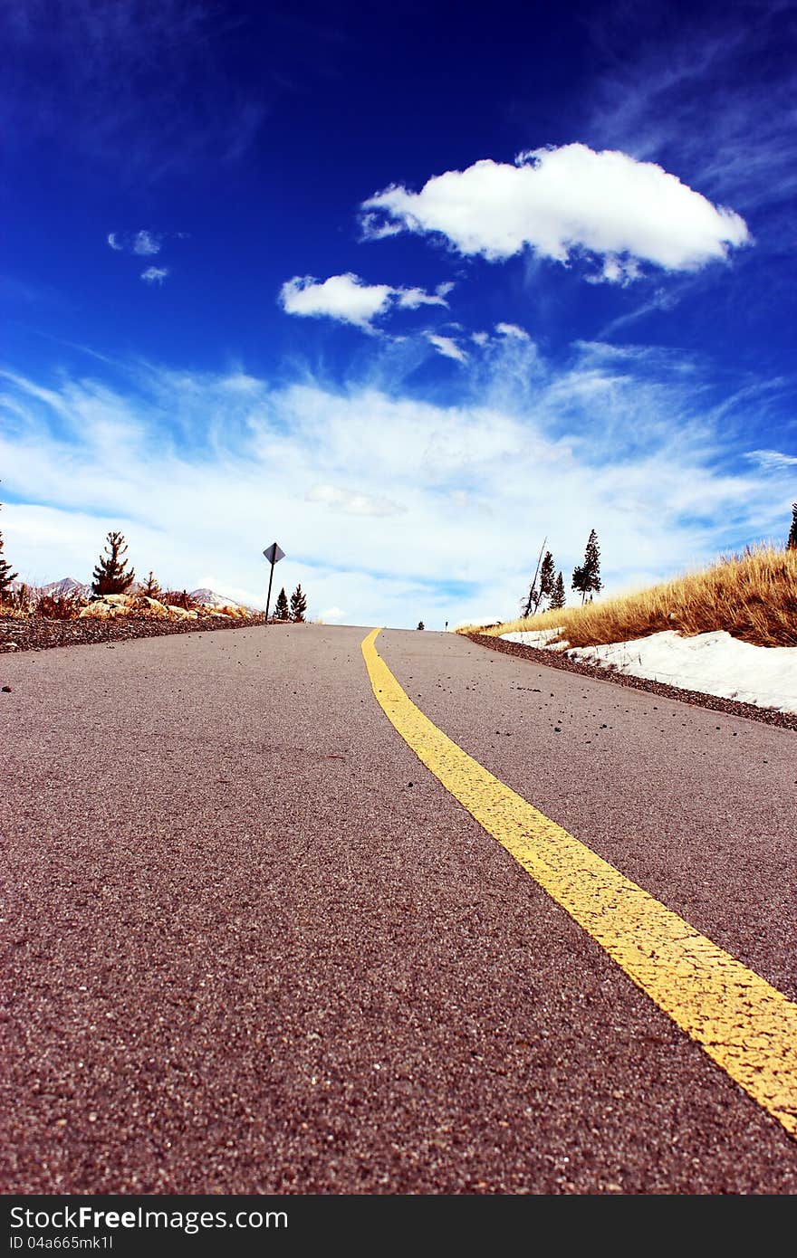 Bike Path disappears into the blue sky and wispy clouds. Bike Path disappears into the blue sky and wispy clouds