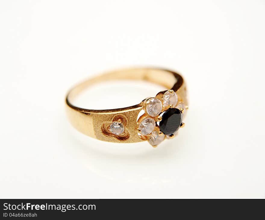 Yellow gold ring with black gemstone, towards white