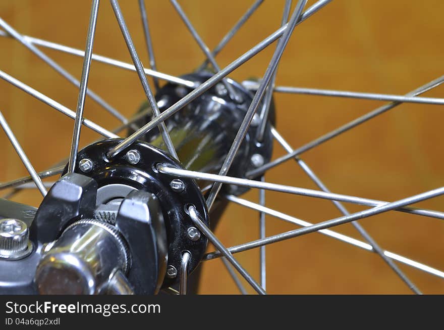 Bicycle wheel fragment; focus on front spokes. Bicycle wheel fragment; focus on front spokes