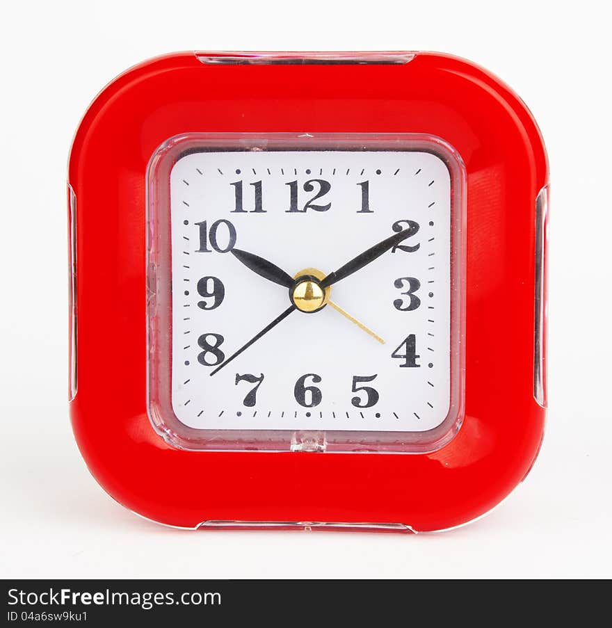 Red alarm clock on a white background