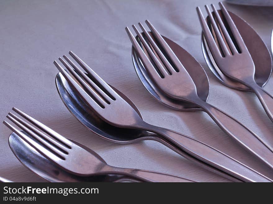 Close-up of many pair of spoon and fork on table