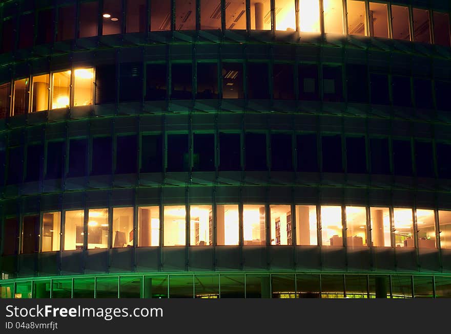 A night-time officebuilding with lights in the windows, closeup. A night-time officebuilding with lights in the windows, closeup