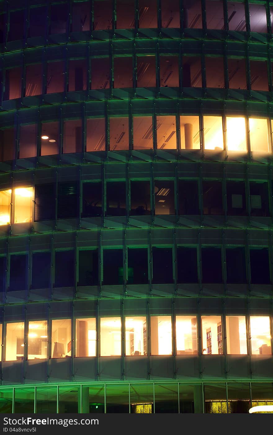 A night-time officebuilding with lights in the windows, closeup. A night-time officebuilding with lights in the windows, closeup