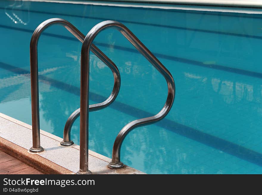 Close-up of swimming pool with stair at hotel , vacation background. Close-up of swimming pool with stair at hotel , vacation background