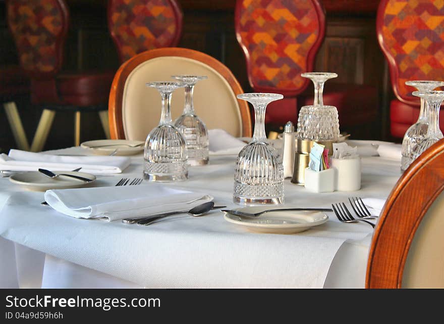 A table for two by a brightly lit window. A table for two by a brightly lit window