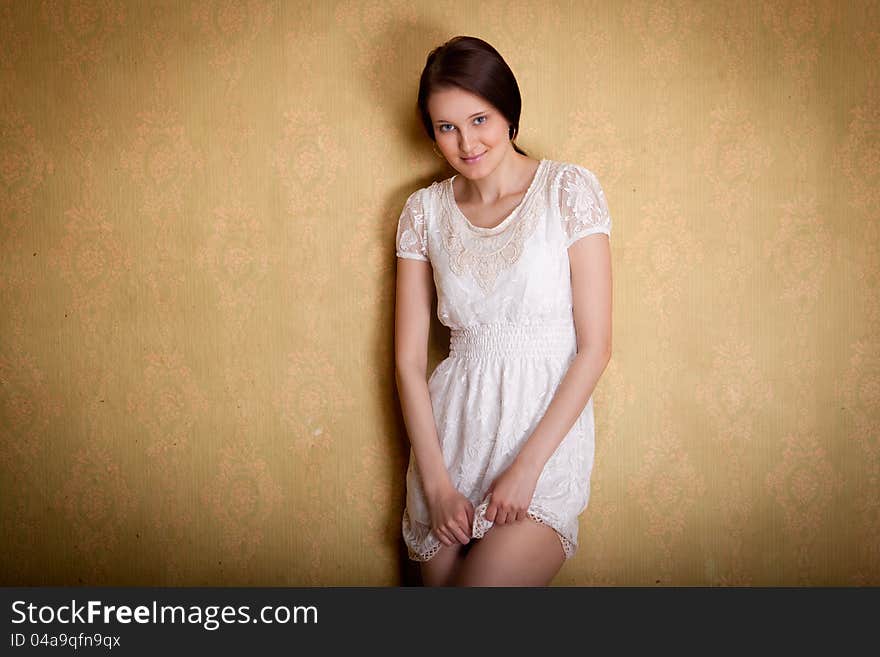 The portrait of the yoing girl on the vintage background. The portrait of the yoing girl on the vintage background