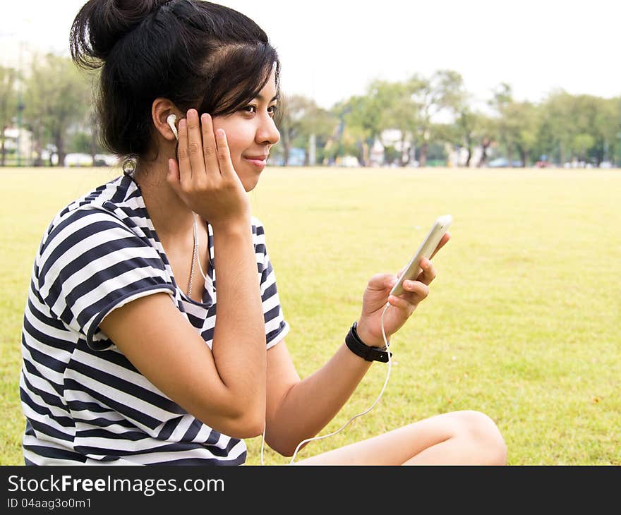 Young girl with headphones outdoors. Listening music. Young girl with headphones outdoors. Listening music