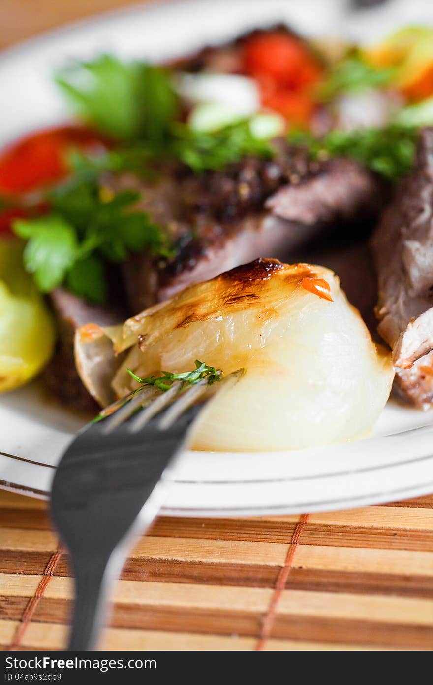 Boiled onion on a plate closeup