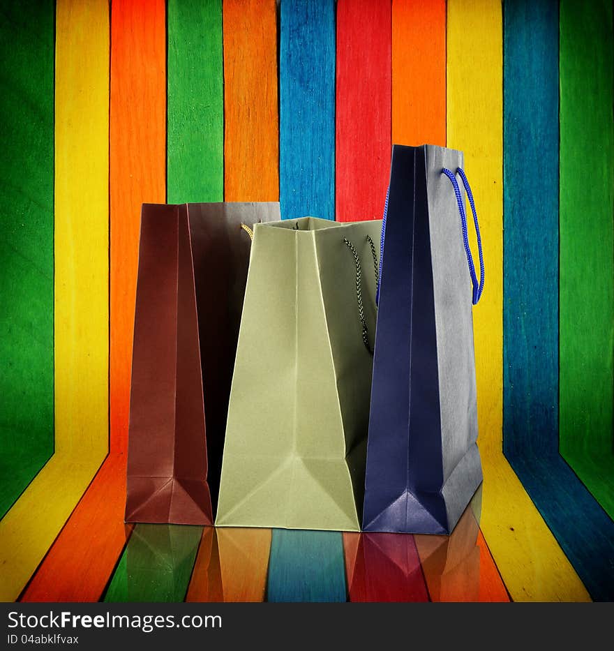 Shopping bags on colorful wood Background