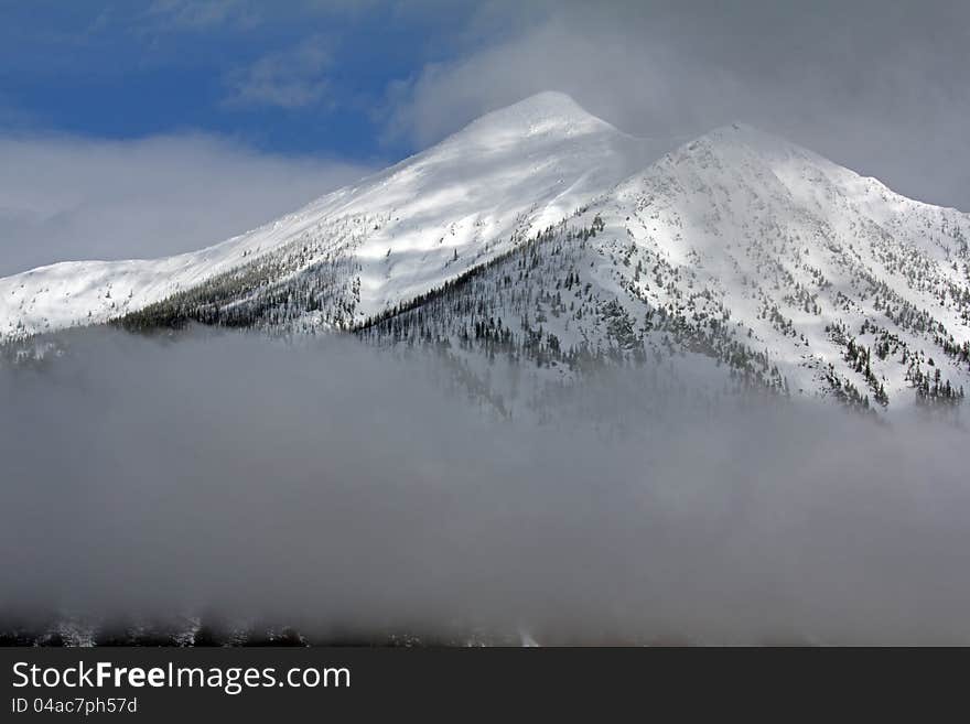 This image of Stanton Mountain with the low clouds was taken in Glacier National Park, MT. This image of Stanton Mountain with the low clouds was taken in Glacier National Park, MT.