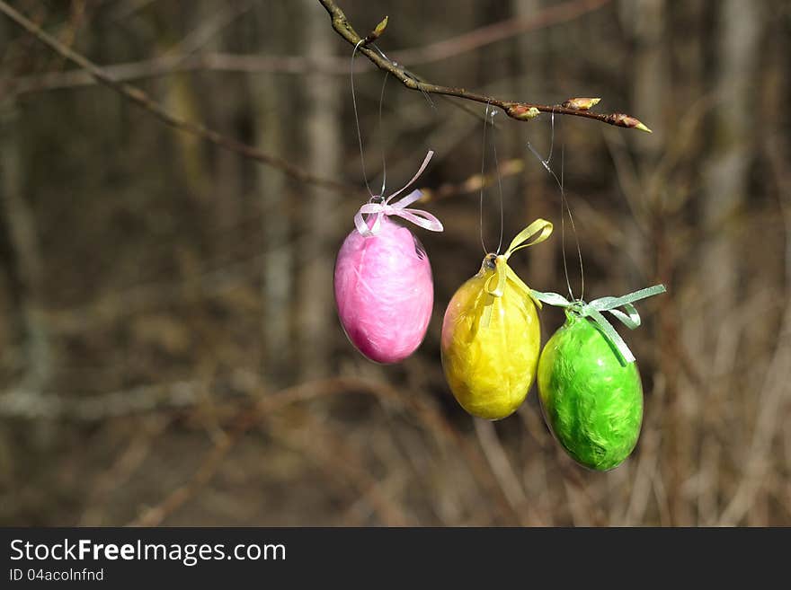 Tree easter egg, pink yellow an green on a branch