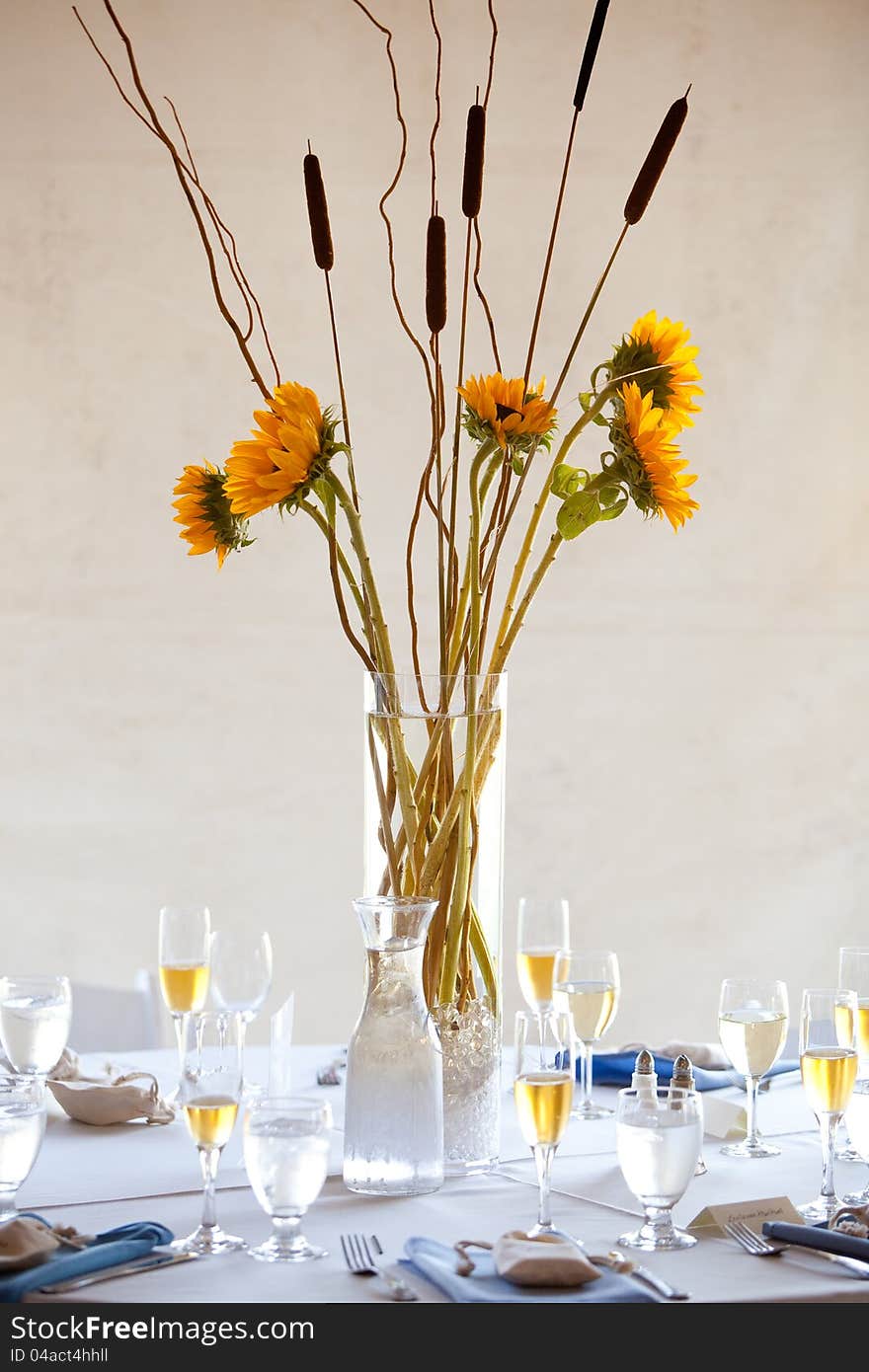 A large wedding table centerpiece with a sunflower bouquet