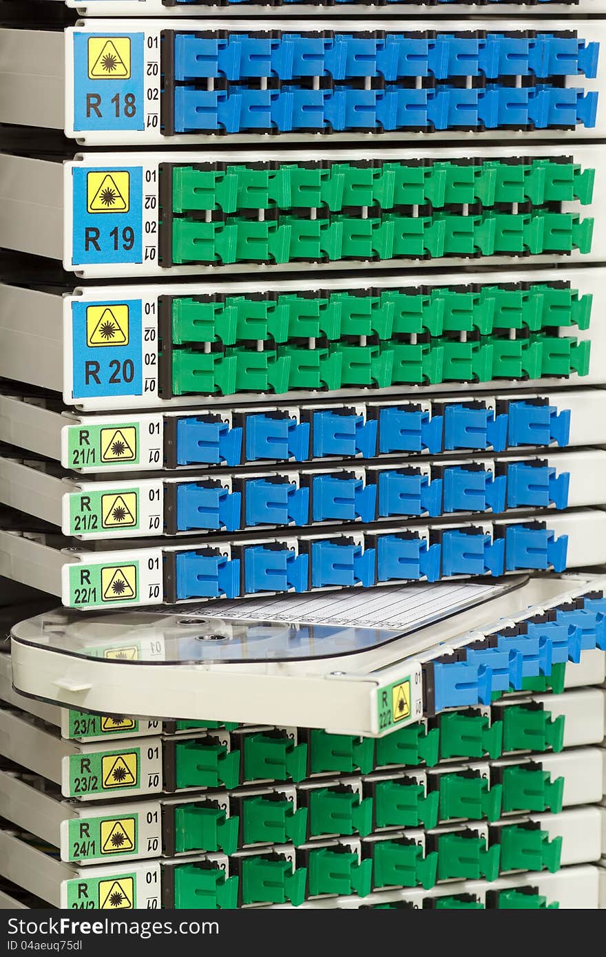 Fiber optic cable management system with green and blue SC connectors. Fiber optic cable management system with green and blue SC connectors