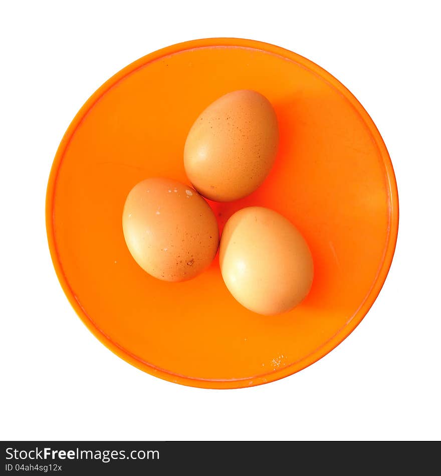 Three brown eggs on kitchen scales isolated on white background