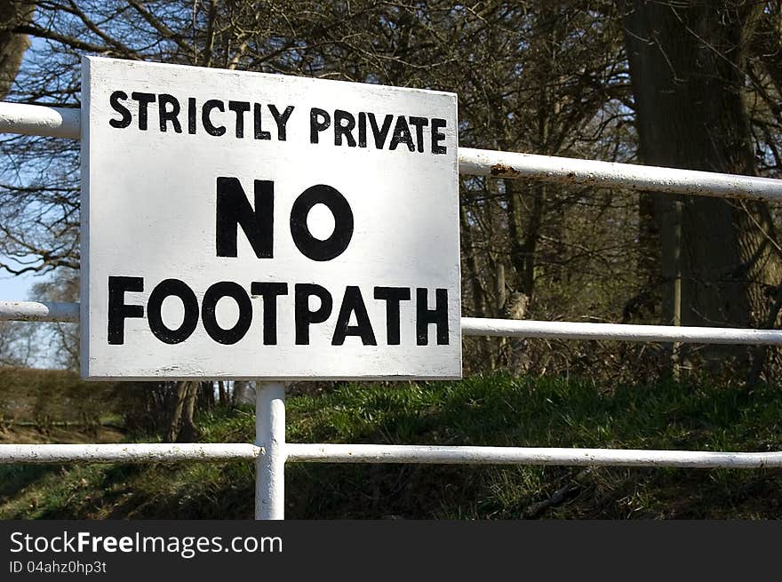 Strictly No Entry sign. White metal gate at entrance to private farmland. Strictly No Entry sign. White metal gate at entrance to private farmland.