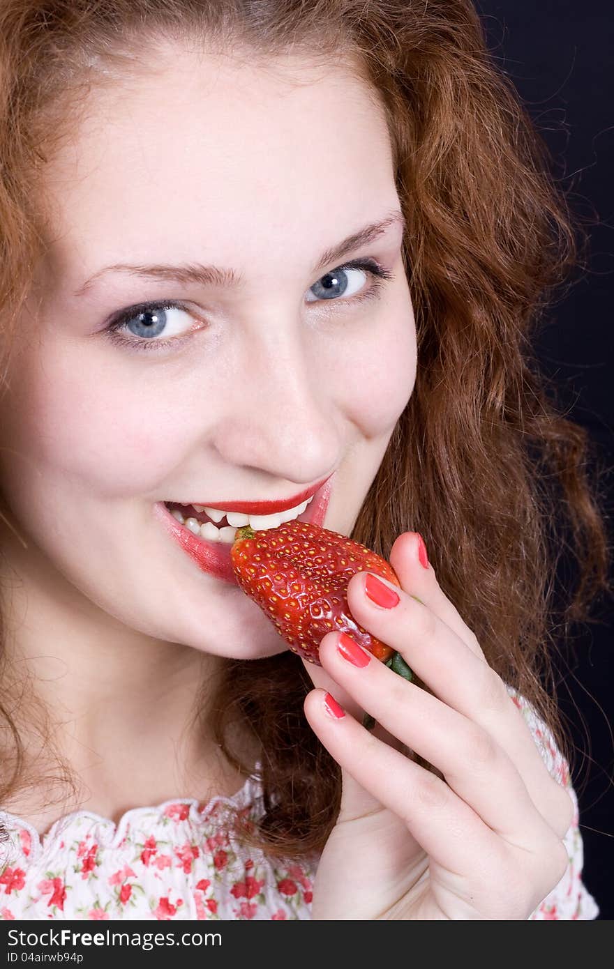 Beautiful girl eating strawberry.