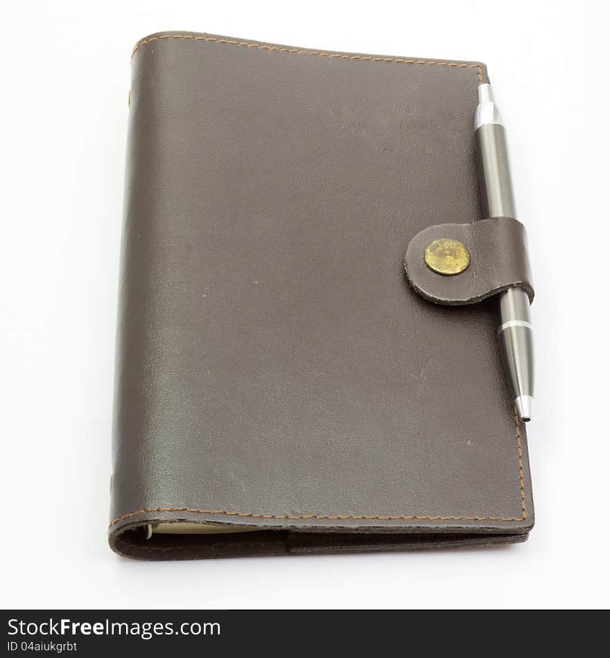 Notebook leather cover and pen on isolated background. Notebook leather cover and pen on isolated background