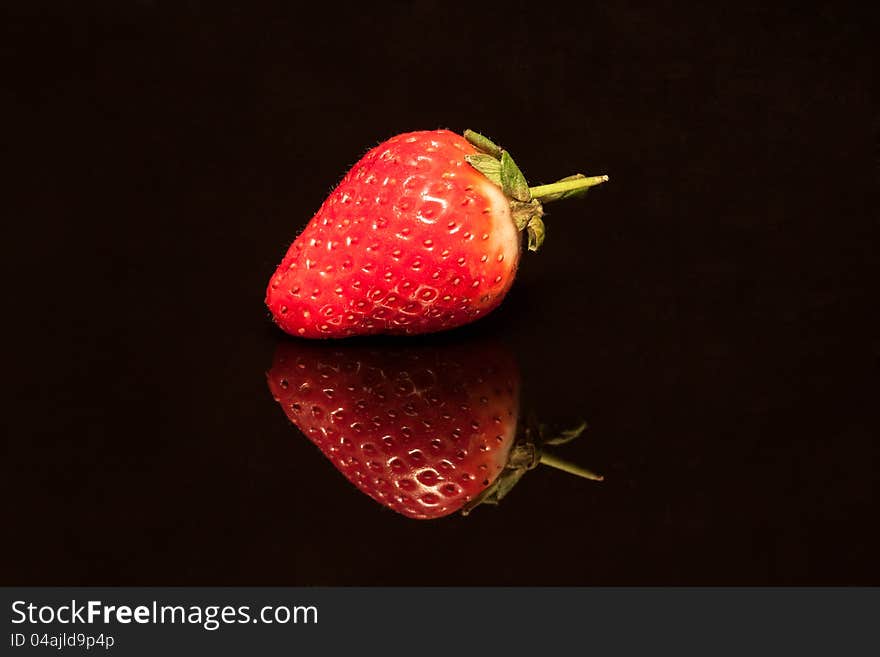 Strawberry isolated on black background.