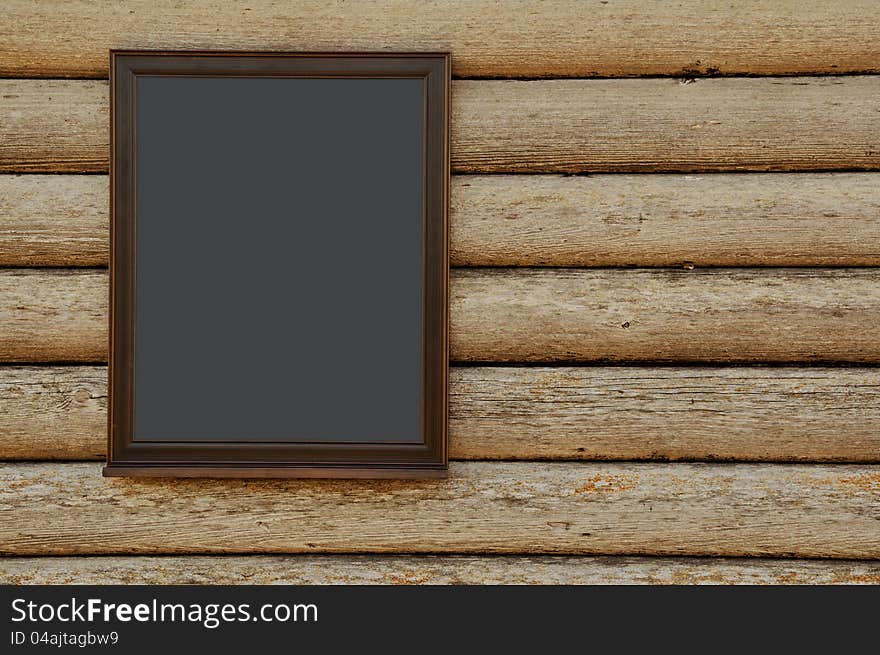 Blank blackboard on rustic wooden wall