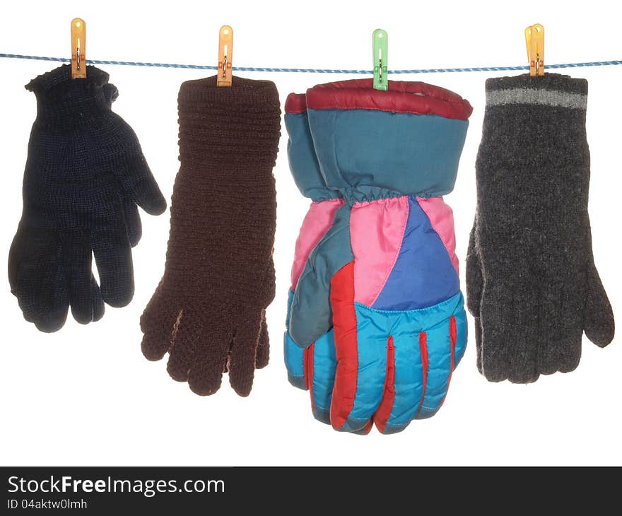 A variety of gloves hanging on a rope