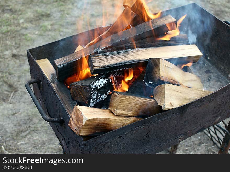 Burning wood in a brazier close-up