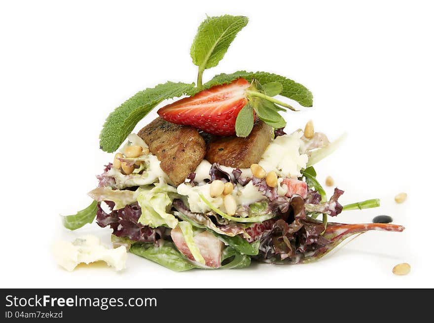 A salad of vegetables and meat on a white background