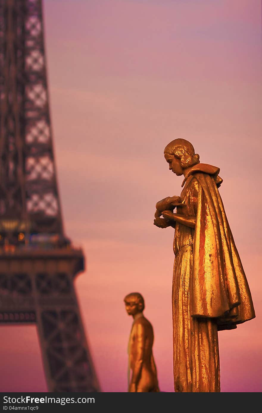 Golden Sculptures In Front Of The Eiffel Tower