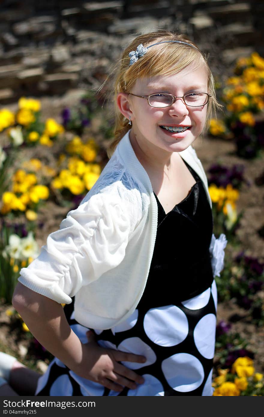 Image of a happy teenager posing in a flower garden. Image of a happy teenager posing in a flower garden