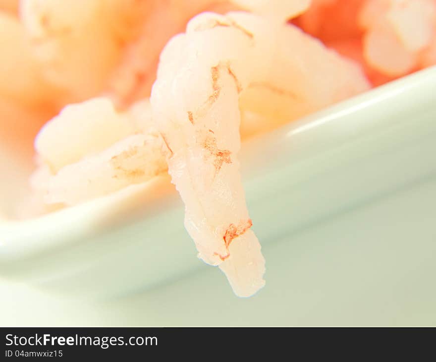 Peeled shrimps, in a white bowl