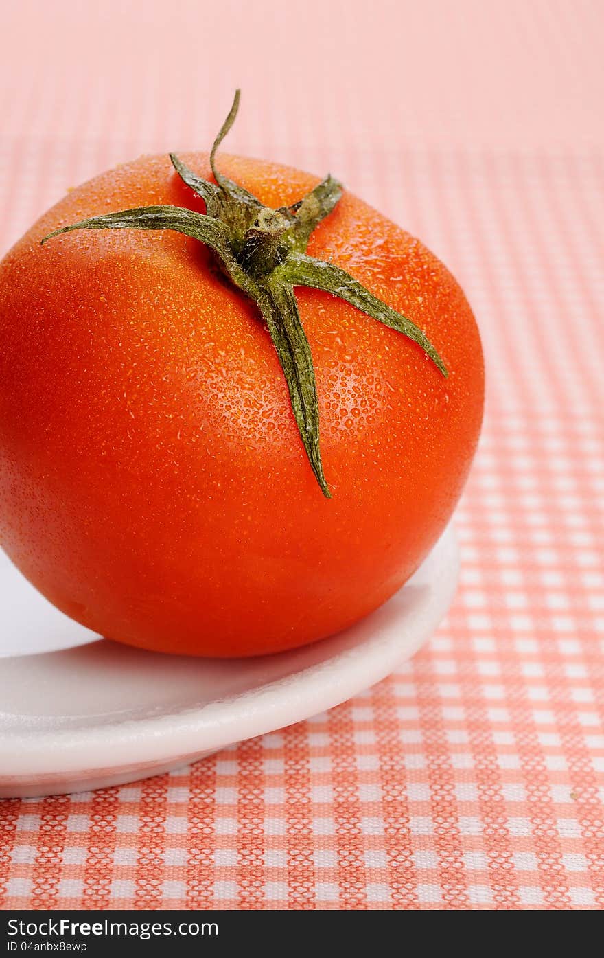 Ripe tomato on the plate. Selective focus