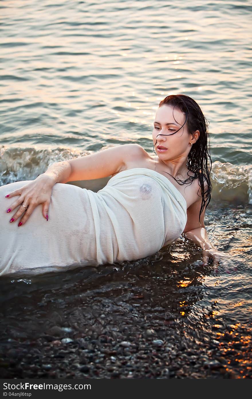 Young girl lying in the sea